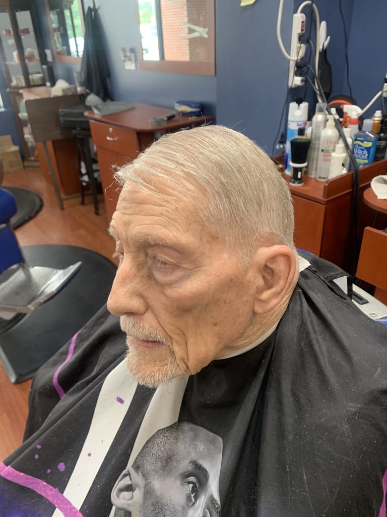 elder client looking to the side after a haircut.